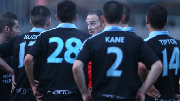 Referee Evan Boyce explains to Ballymena players his decision to stop the game at Milltown because of floodlight failure with United leading 2-1. Play resumed after repairs and Warrenpoint equalised to secure a draw