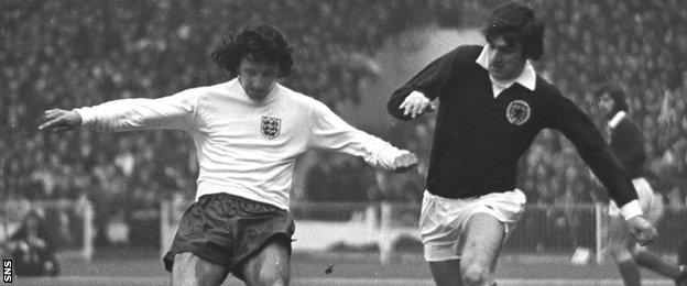 Peter Lorimer (right) closes down England defender Roy McFarland at Wembley in 1973