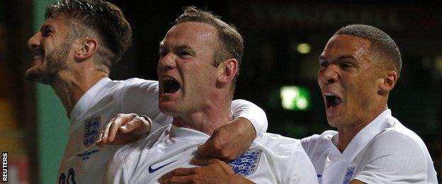 Wayne Rooney celebrates with Adam Lallana and Kieran Gibbs after England's third goal