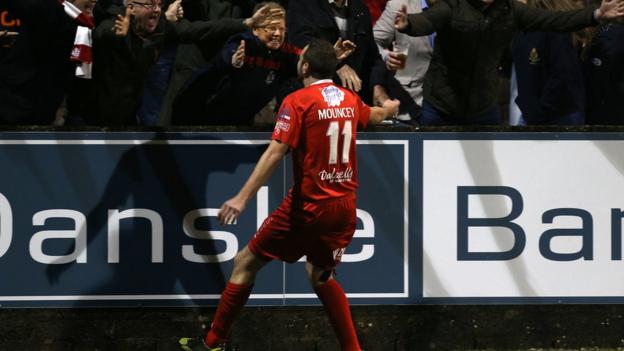 Substitute Tim Mouncey takes the acclaim of Portadown supporters after scoring an injury-time winner
