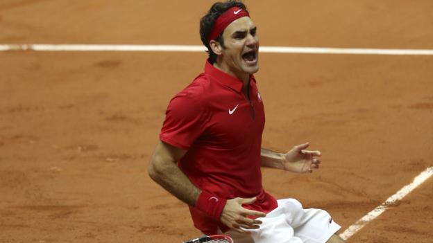 _79212645_federer_wins_knees_ap.jpg