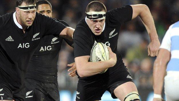 Brodie Retallick carries the ball for New Zealand with team-mate Wyatt Crockett (left) in support