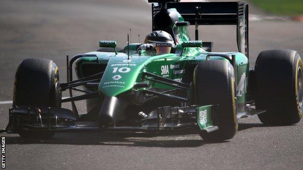 Caterham car of Kamui Kobayashi competing at the Abu Dhabi Grand Prix