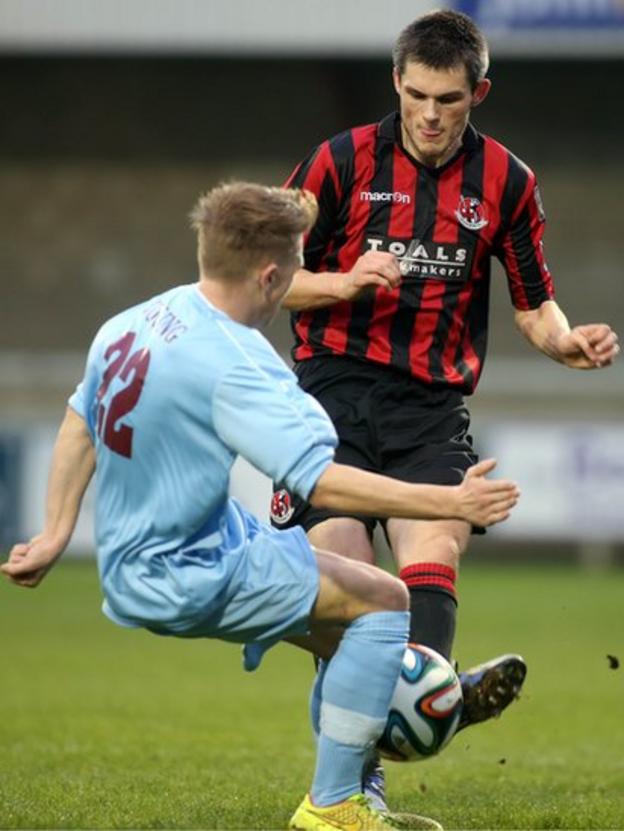 Matty Young of Institute challenges Crusaders defender Craig McClean for the ball during the 1-1 draw at Drumahoe