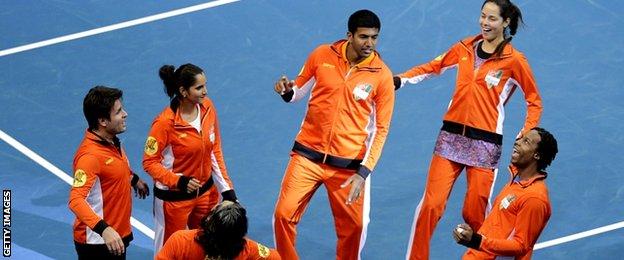 Indian Aces team (R-L) Gael Monfils of France, Ana Ivanovic of Serbia, Rohan Bopanna of India, Sania Mirza of India and Fabrice Santoro of France dance as they celebrate