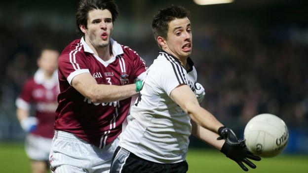 Karl McKaigue of Slaughtneil competes with Omagh's Ronan O'Neill during the 2014 Ulster Senior Club Championship final