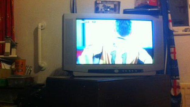 Maidstone fan Tom West watches his side on the television
