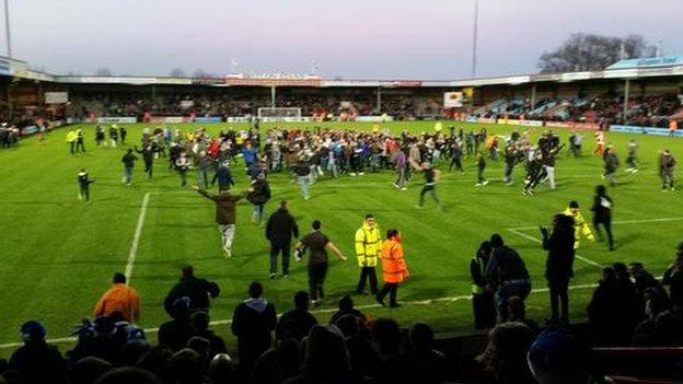 Paul Jones captures the Worcester City fans pitch invasion at Scunthorpe