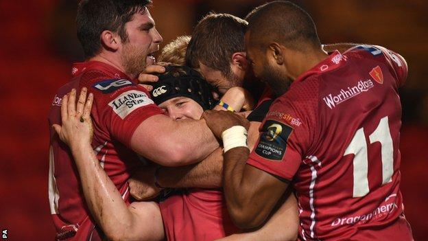 James Davies (centre in scrum cap) is mobbed by his team-mates after scoring the decisive try for Scarlets
