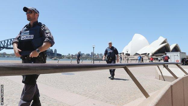 Armed police patrol near the Sydney Opera House