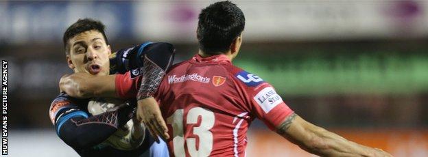 Cardiff Blues' Lucas Amorosino is stopped by Scarlets' Regan King