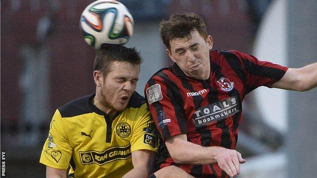 An aerial duel between Cliftonville defender Jaimie McGovern and Crusaders opponent BJ Burns