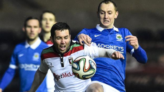 Glentoran's Niall Henderson and Linfield midfielder Sammy Morrow battle for possession in the Big Two showdown at Windsor Park