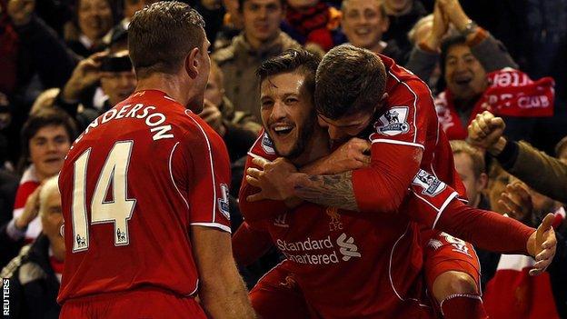 Liverpool players celebrate against Swansea
