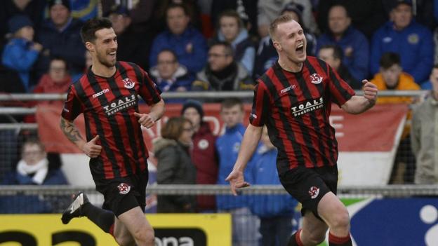 Crusaders striker Jordan Owens runs away in delight after scoring in the first minute against Linfield at Seaview on New Year's Day