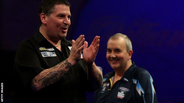 Phil Taylor watches on as Gary Anderson celebrates
