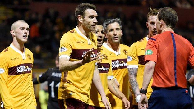 Motherwell players, including Stephen McManus, compain to referee Willie Collum
