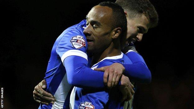 Chris O'Grady celebrates his first goal for Brighton with Solly March