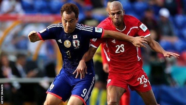 Shinji Okazaki (left) in action for Japan in the Asian Cup against Palestine