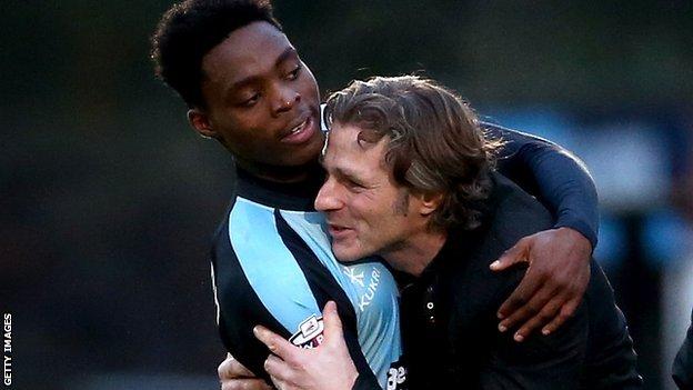 Fred Onyedinma (l) hugs Wycombe Wanderes boss Gareth Ainswoth
