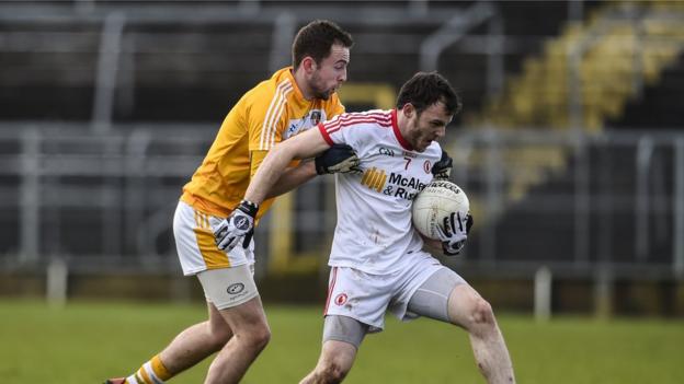 Antrim's Emmet Killough challenges Tyrone's Barry Tierney for possession during the McKenna Cup game which was moved to Clones