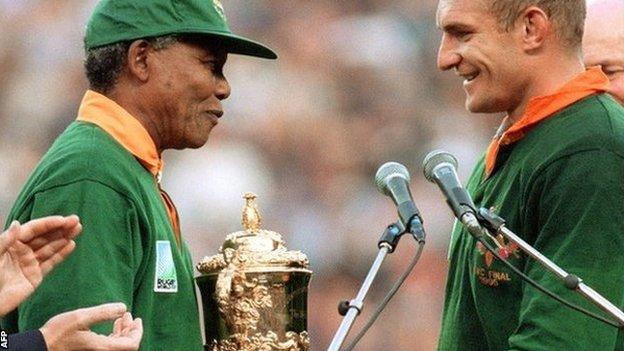 South African President Nelson Mandela presents the World Cup to Springbok captain Francois Pienaar in 1995