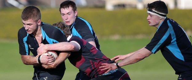 The run of Carrick GS player Tom Gilpin is halted by BRA's David McCullough in the second-round clash