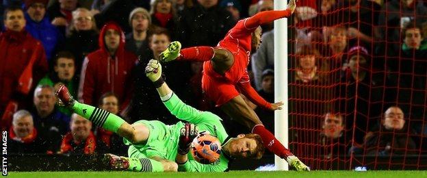 Bolton goalkeeper Adam Bogdan (bottom) and Liverpool's Raheem Sterling