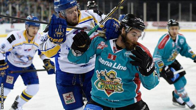 Fife's Chris Wands puts in a strong challenge on Belfast forward Darryl Lloyd