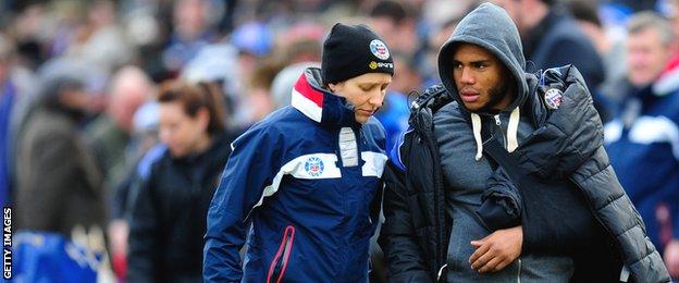 Bath's England centre Kyle Eastmond is led away with his arm in a sling