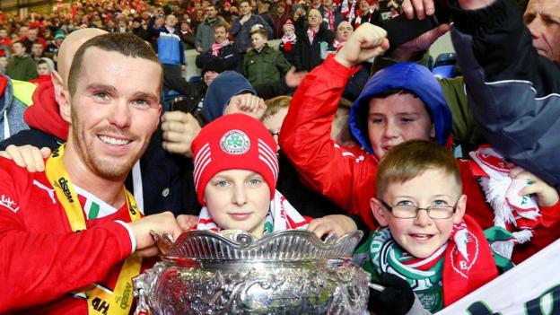 Martin Donnelly celebrates with young Cliftonville fans after the League Cup final win over Ballymena United