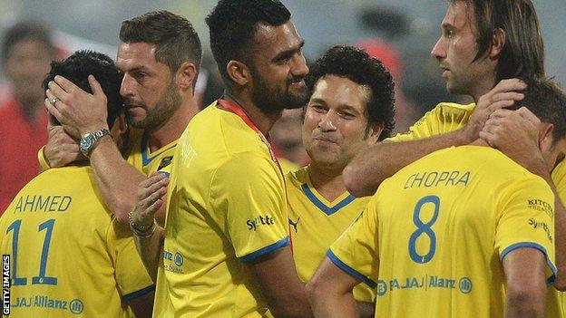 Jamie McAllister (second left) and Sachin Tendulkar commiserate Kerala's players after losing the Indian Super League final