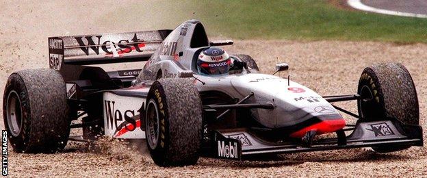 Mika Hakkinen drives through a gravel trap at the