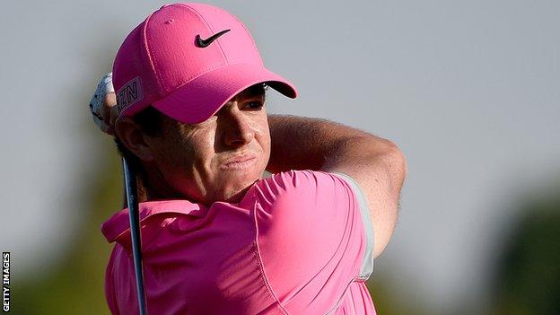 Rory McIlroy watches his second shot at the 18th on Friday