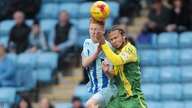 Curtis Thompson (right) challenges Coventry's Ryan Haynes