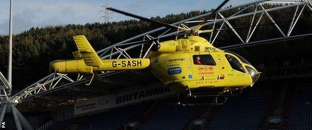 A helicopter takes Huddersfield's Tommy Smith to hospital
