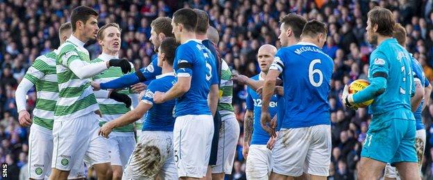 Celtic and Rangers players take part in an on-field spat