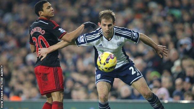 Craig Dawson of West Brom holds off Swansea's Jefferson Montero