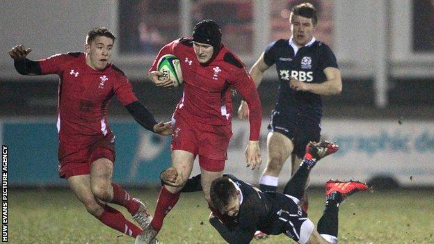 Wales' Dafydd Howells is tackled by Rory Hutchinson