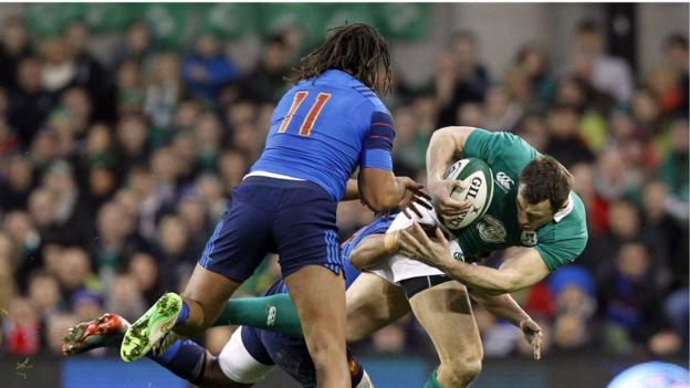 France wing Teddy Thomas prepares to help a team-mate tackle Ireland's Tommy Bowe at the Aviva Stadium