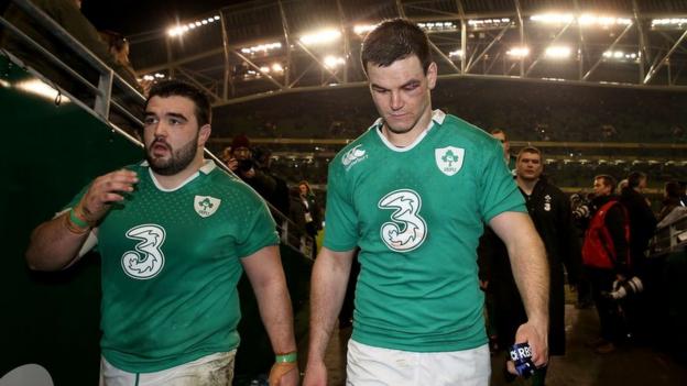 Ireland replacement prop Marty Moore leaves the field with Jonny Sexton after the hard-fought win over France