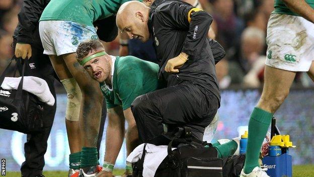 Jamie Heaslip receives treatment after suffering the injury to his lower back