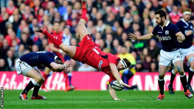 Dan Biggar is upended in a collision with opposite number Finn Russell