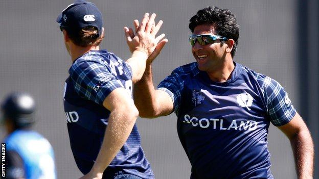 Scotland's Majid Haq celebrates the wicket of Ross Taylor in Dunedin
