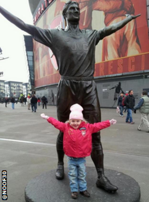 Child next to statue of Tony Adams