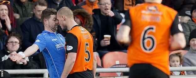 St Johnstone's Steven MacLean and Jaroslaw Fojut square up in the second half at Tannadice