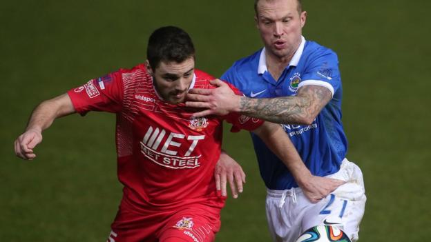 Portadown's Chris Ramsey and Linfield player/manager Warren Feeney tussle for possession in Friday night's game Windsor Park