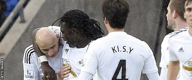 Bafetimbi Gomis celebrates with after Jonjo Shelvey after they combined to seal Swansea's winner