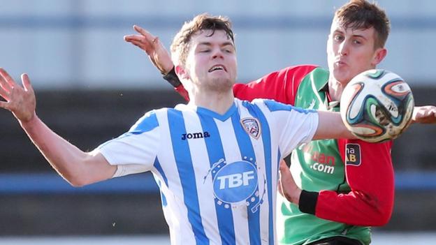 Coleraine's Shane McGinty shields the ball from Glens opponent Marcus Kane in Saturday's 1-1 draw
