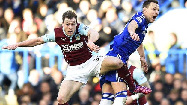 Burnley forward Ashley Barnes (left) goes up for a challenge with Chelsea captain John Terry
